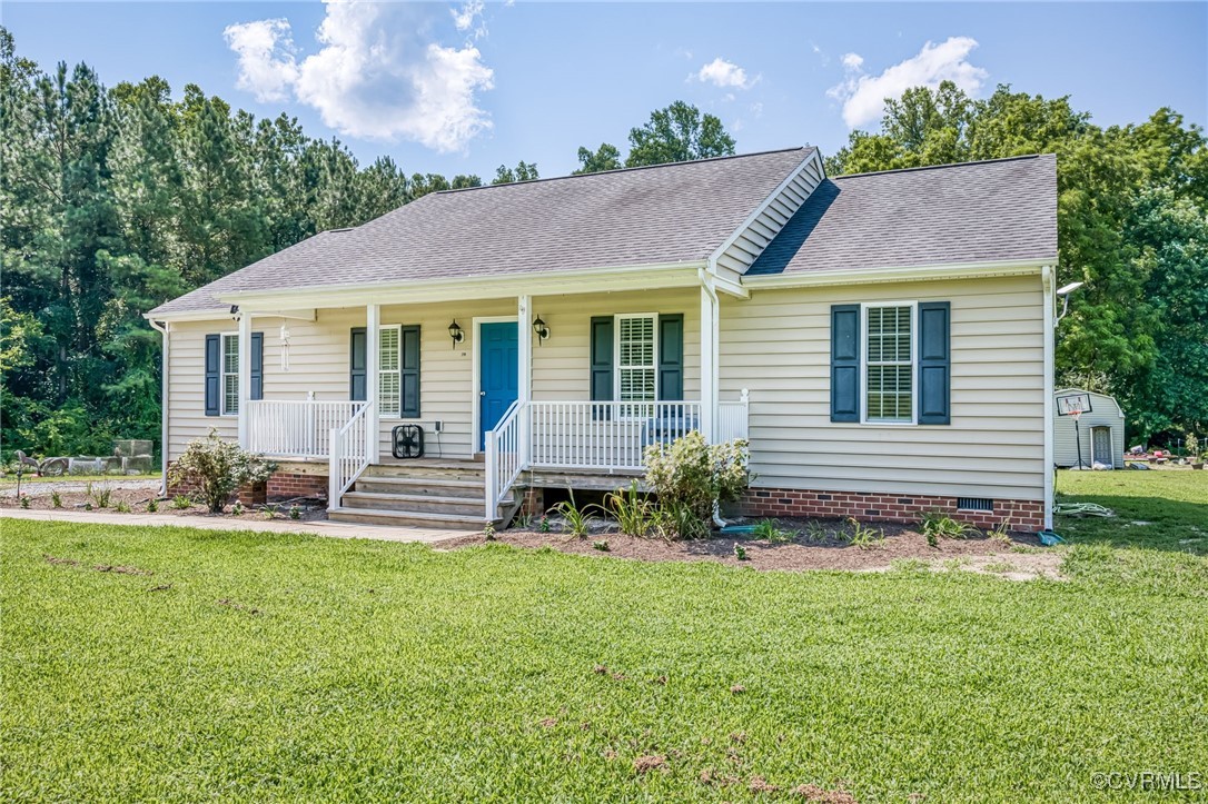 a view of a house with a yard and sitting area