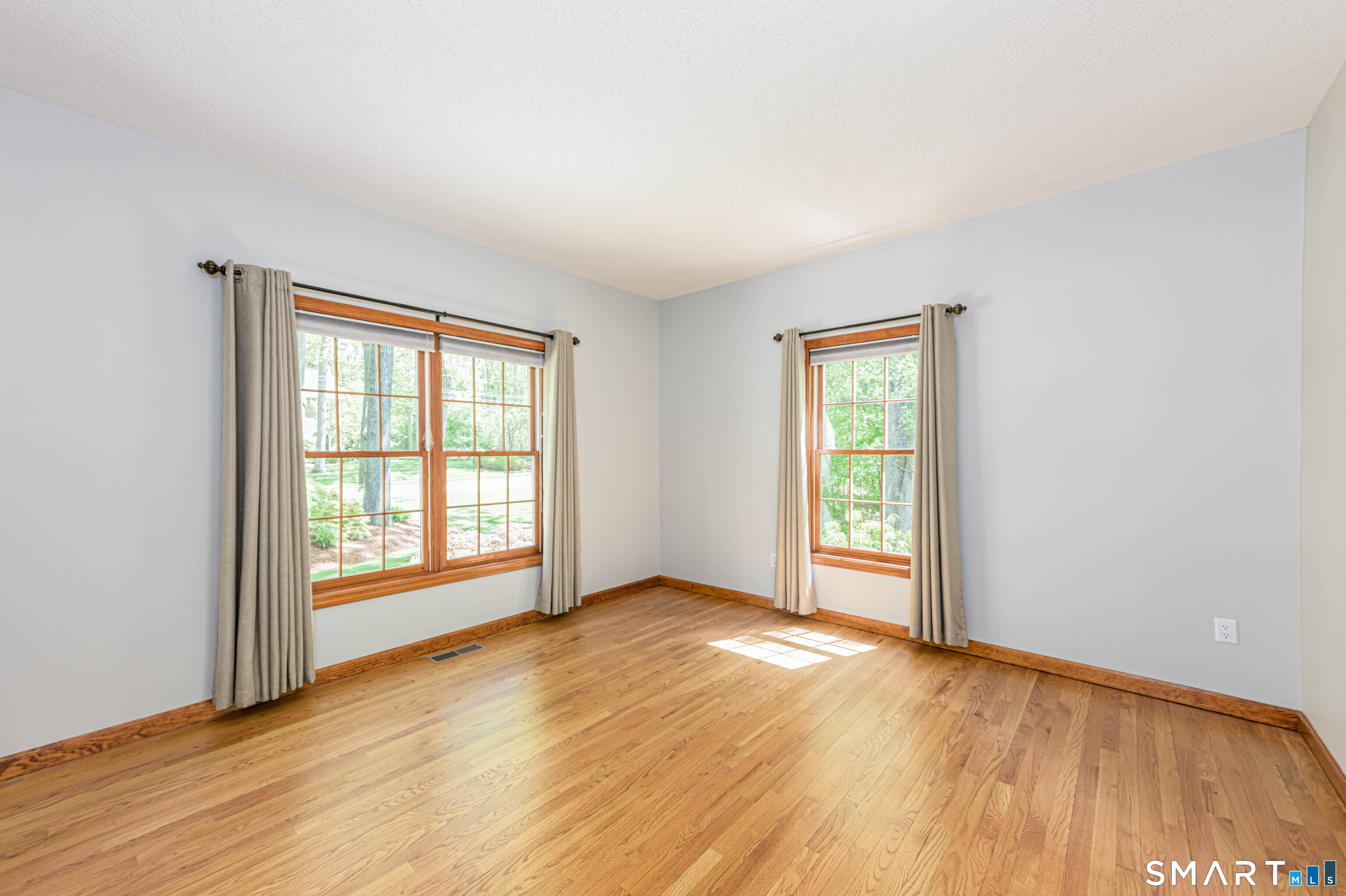 4 Crystal Lane Wallingford, CT 06492 - Photo 11 of 40 an empty room with wooden floor and windows