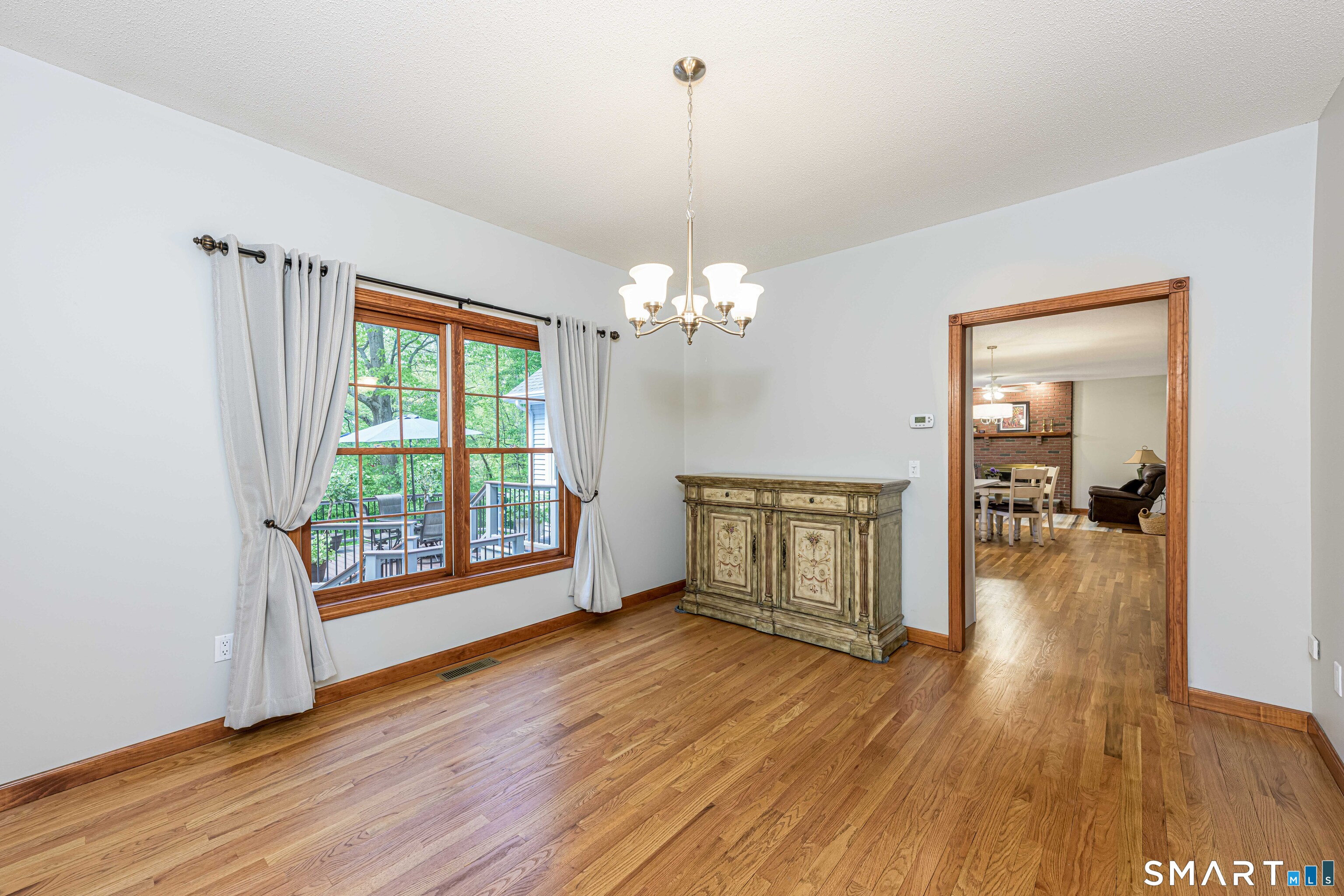 4 Crystal Lane Wallingford, CT 06492 - Photo 12 of 40 a view of a room with wooden floor fireplace and windows