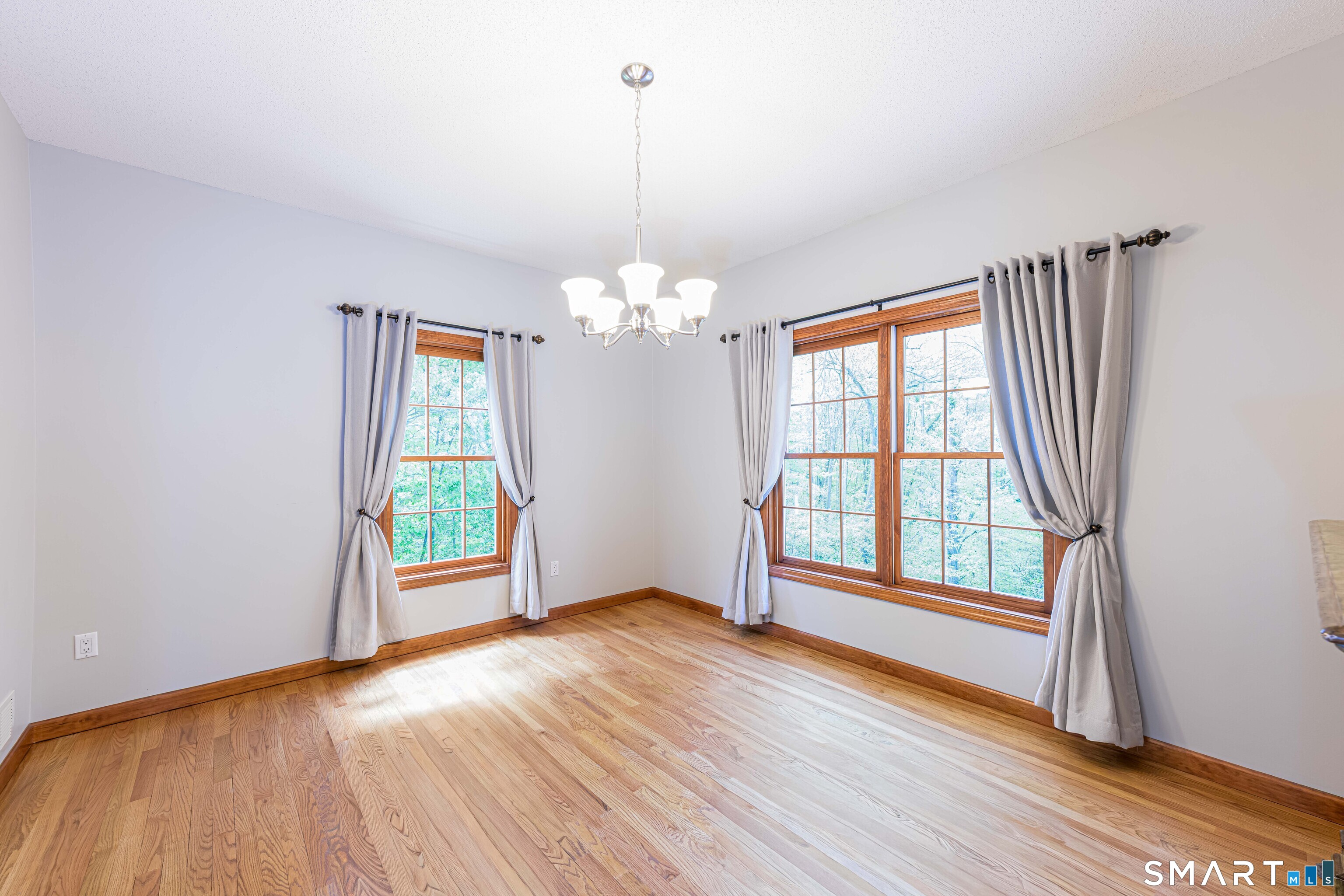 4 Crystal Lane Wallingford, CT 06492 - Photo 13 of 40 a view of an empty room with wooden floor and a window