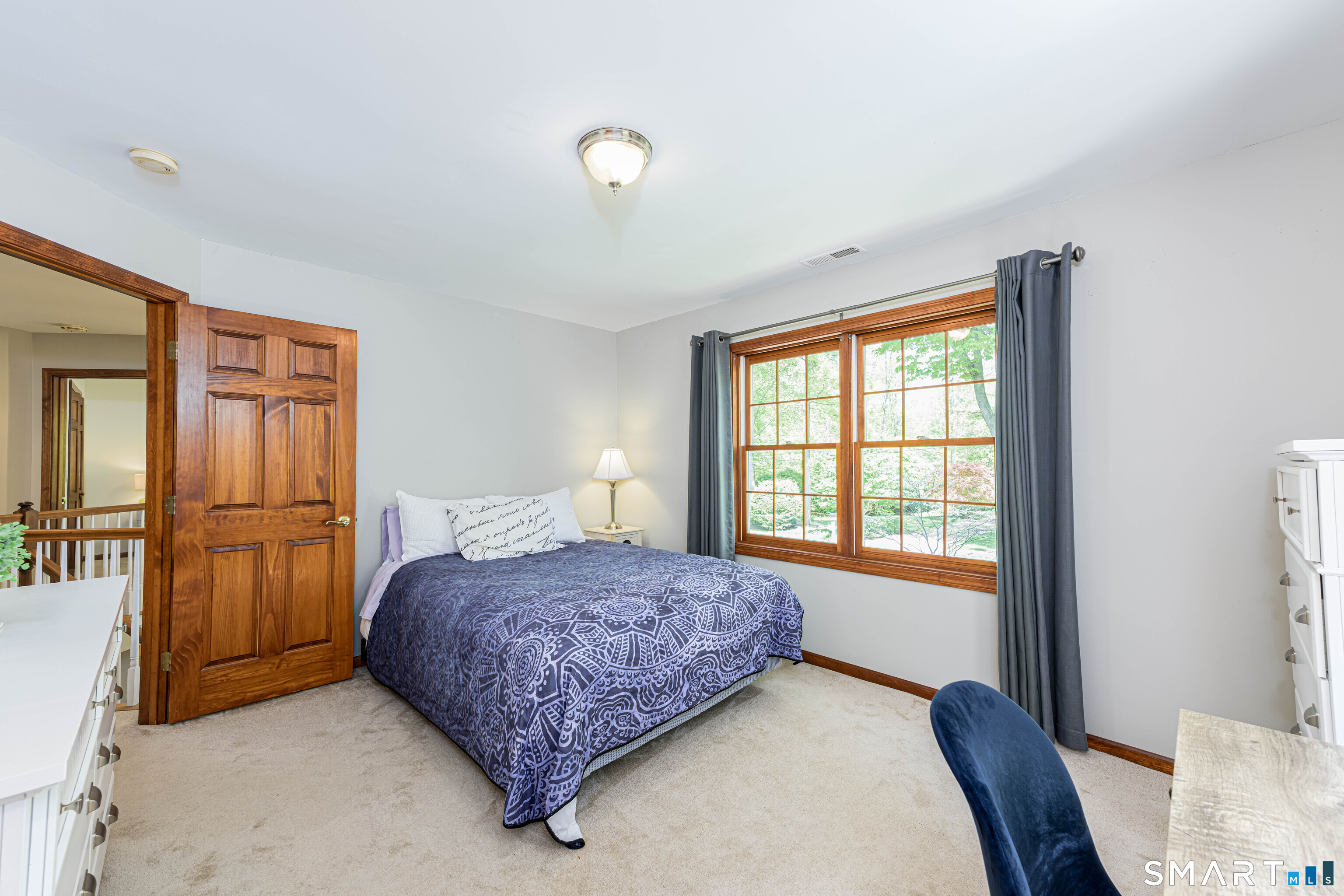 4 Crystal Lane Wallingford, CT 06492 - Photo 27 of 40 a bedroom with a bed and dresser with mirror