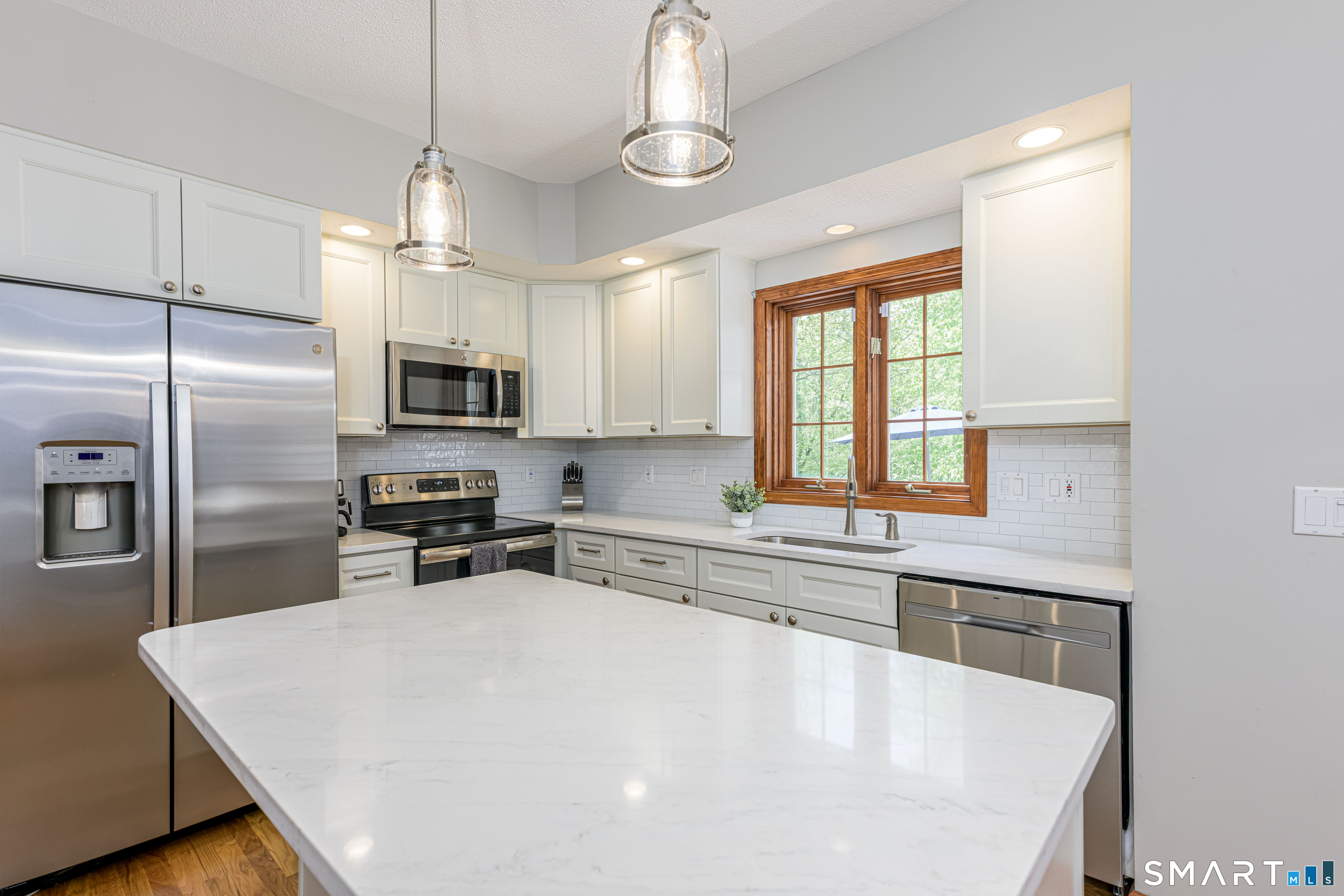 4 Crystal Lane Wallingford, CT 06492 - Photo 3 of 40 a kitchen with stainless steel appliances a sink a stove a refrigerator cabinets and a window