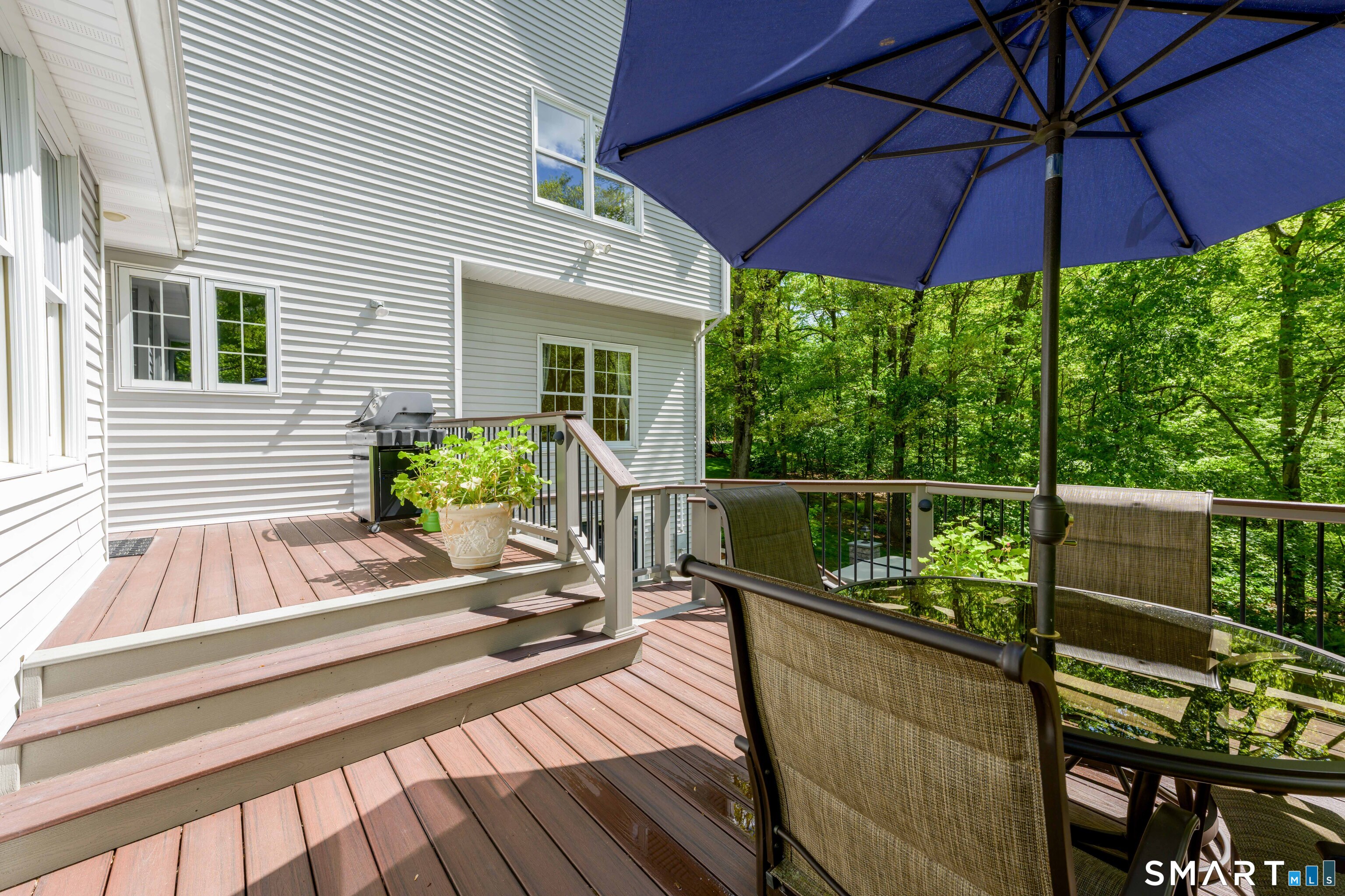 4 Crystal Lane Wallingford, CT 06492 - Photo 33 of 40 a view of a deck with couches under an umbrella