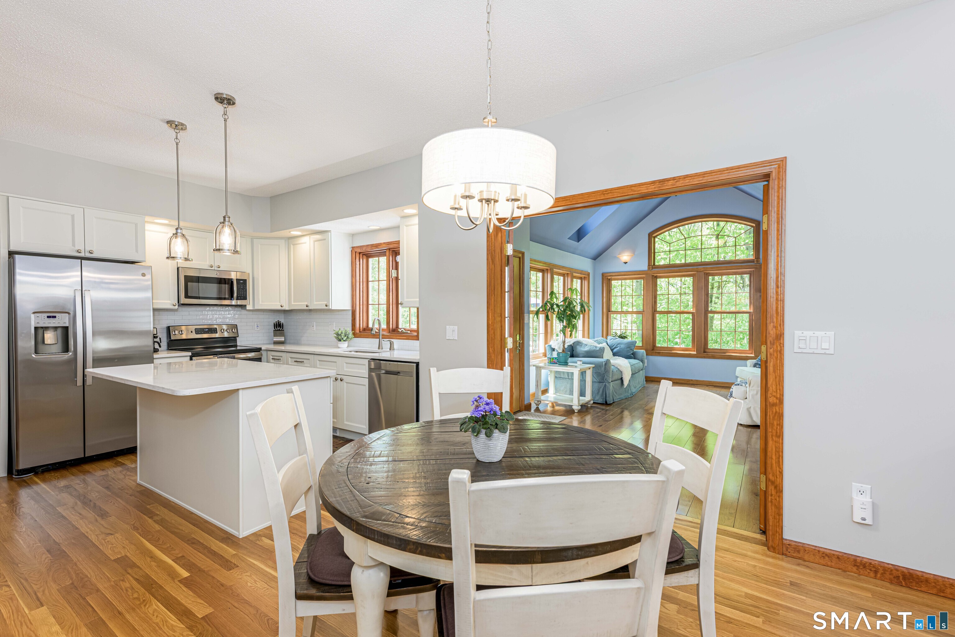 4 Crystal Lane Wallingford, CT 06492 - Photo 5 of 40 a kitchen with sink refrigerator dining table and chairs