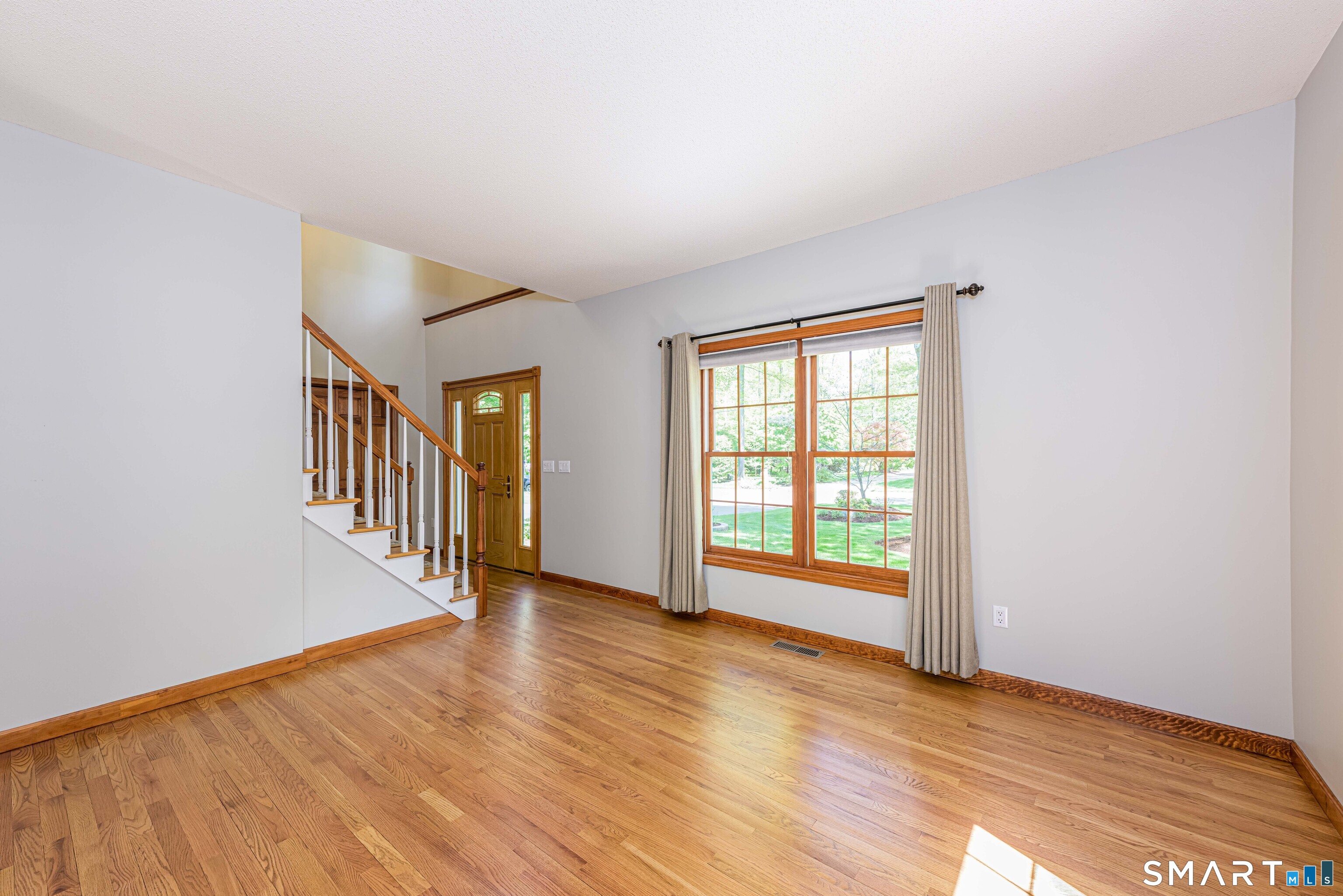 4 Crystal Lane Wallingford, CT 06492 - Photo 10 of 40 a view of an empty room with wooden floor and a window
