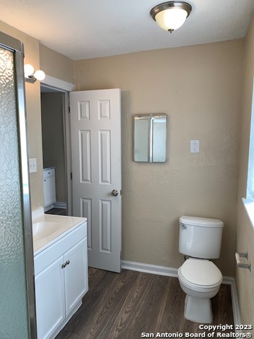 403 Terrell Avenue, Unit 3 San Antonio, TX 78214 - Photo 11 of 14 a bathroom with a toilet sink and mirror