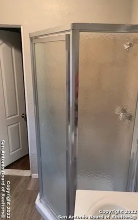 a bathroom with a glass door shower