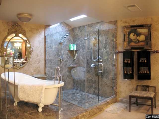 2464 East Lakeridge Reno, NV 89509 - Photo 7 of 9 a bathroom with a tub shower and mirror