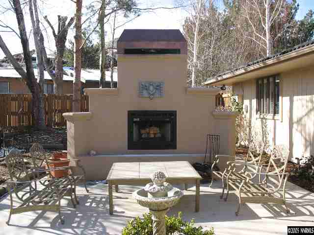 2464 East Lakeridge Reno, NV 89509 - Photo 8 of 9 a view of a patio with table and chairs with wooden floor and fence