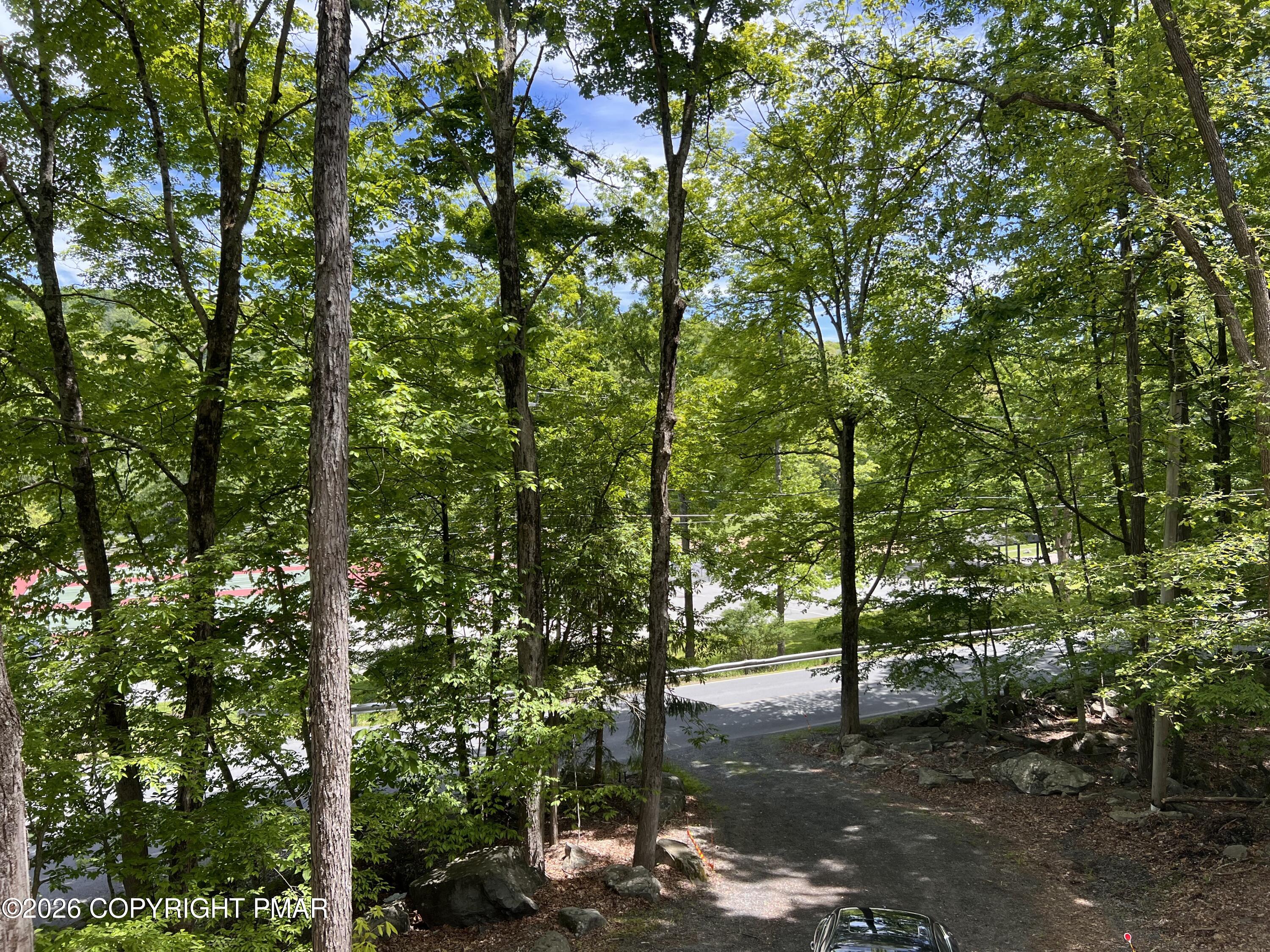 5709 Decker Road Bushkill, PA 18324 - Photo 25 of 32 a backyard of a house with lots of trees