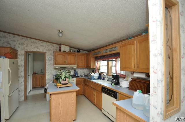 406 Levis Road Nazareth, PA 18064 - Photo 6 of 21 a kitchen with stainless steel appliances kitchen island granite countertop a refrigerator and a sink