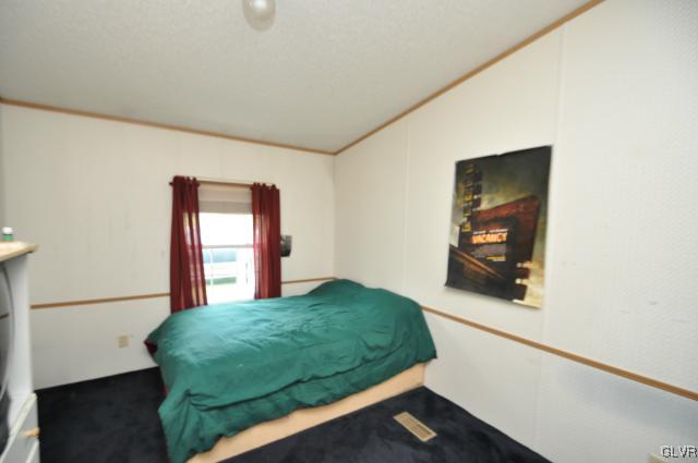 406 Levis Road Nazareth, PA 18064 - Photo 10 of 21 a living room with a bed furniture and a flat screen tv