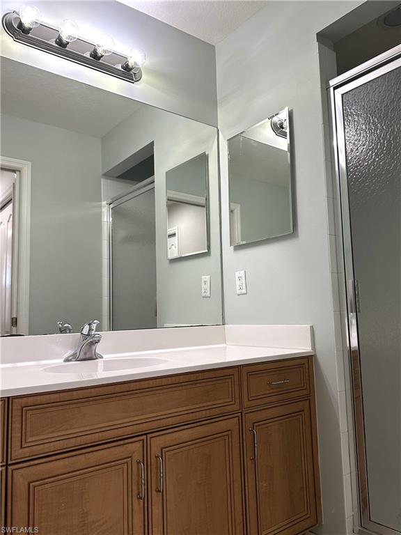 8490 Kingbird Loop, Unit 934 Estero, FL 33967 - Photo 20 of 33 a bathroom with a sink and a mirror