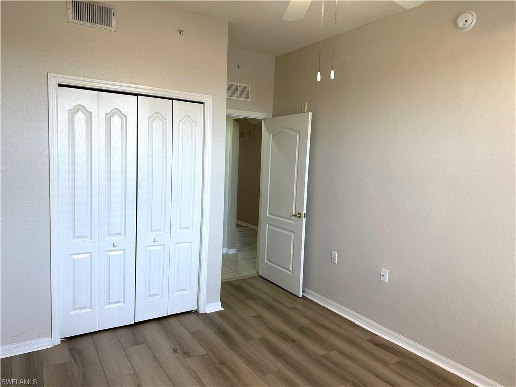 8490 Kingbird Loop, Unit 934 Estero, FL 33967 - Photo 23 of 33 a view of an empty room with wooden floor