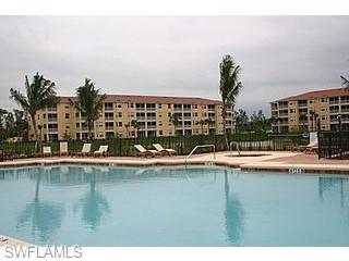 8490 Kingbird Loop, Unit 934 Estero, FL 33967 - Photo 27 of 33 a view of a swimming pool with outdoor seating