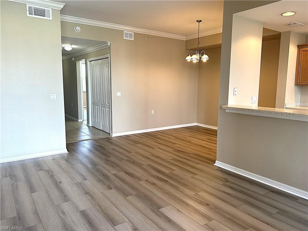 8490 Kingbird Loop, Unit 934 Estero, FL 33967 - Photo 7 of 33 an empty room with wooden floor and windows