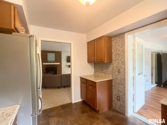 a kitchen with granite countertop white cabinets and stainless steel appliances