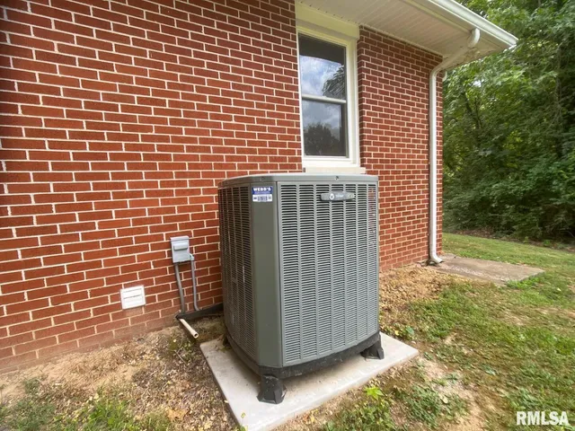 a view of a house with a yard and large tree