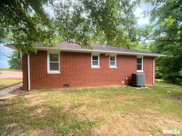 a view of a backyard with large trees