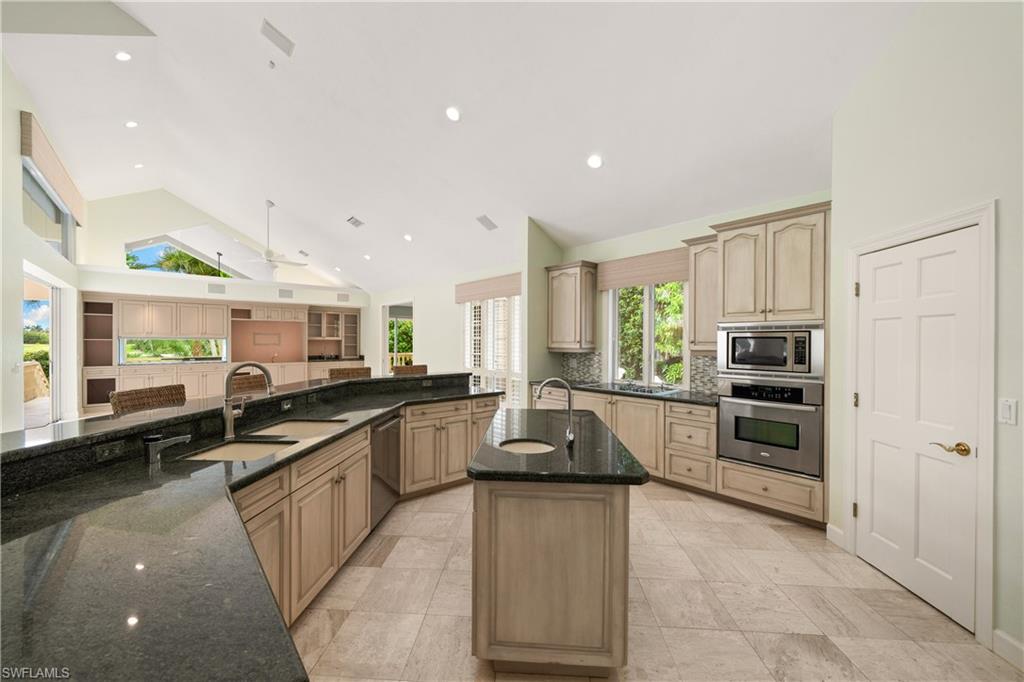 2969 Wulfert Road Sanibel, FL 33957 - Photo 15 of 44 a kitchen with stainless steel appliances granite countertop a stove a sink and a refrigerator