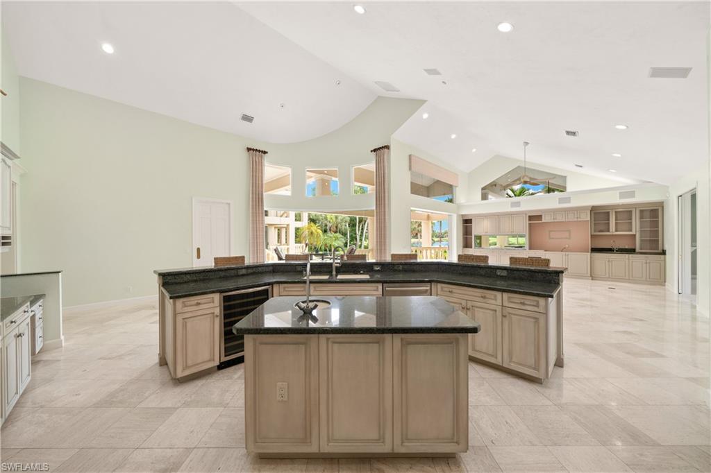 2969 Wulfert Road Sanibel, FL 33957 - Photo 16 of 44 a kitchen with stainless steel appliances granite countertop a stove a sink and a refrigerator