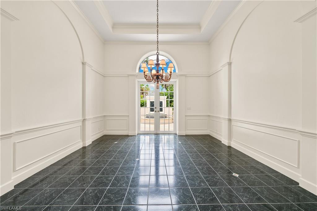 2969 Wulfert Road Sanibel, FL 33957 - Photo 23 of 44 a view of a hallway with windows and chandelier
