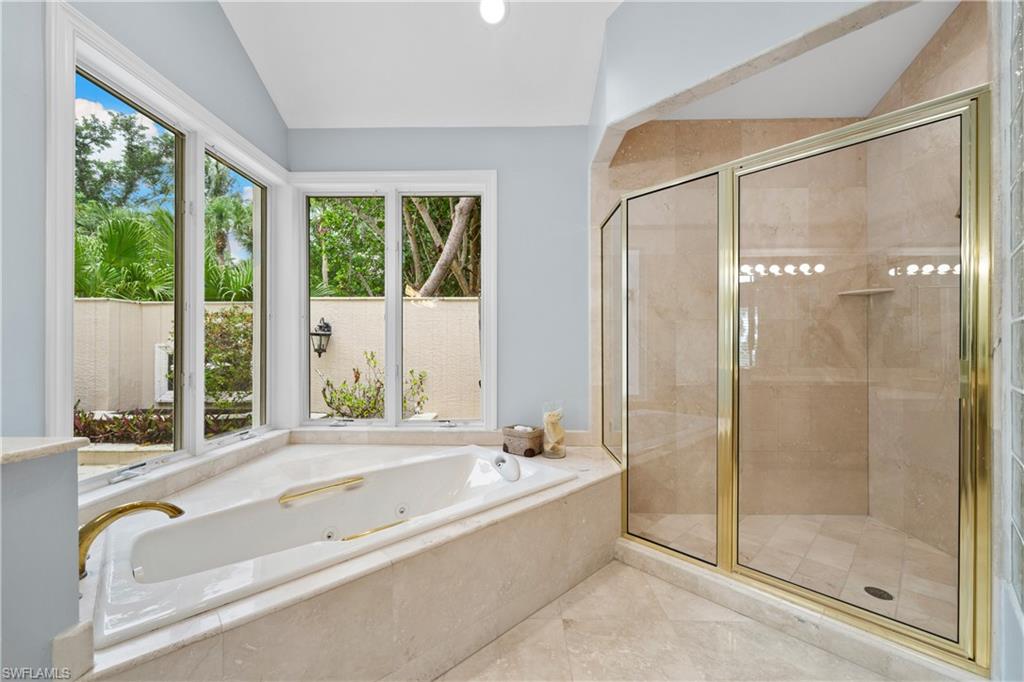 2969 Wulfert Road Sanibel, FL 33957 - Photo 32 of 44 a spacious bathroom with a tub shower and windows