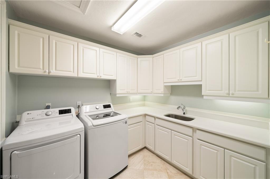 2969 Wulfert Road Sanibel, FL 33957 - Photo 34 of 44 a kitchen with cabinets appliances a sink and a counter top