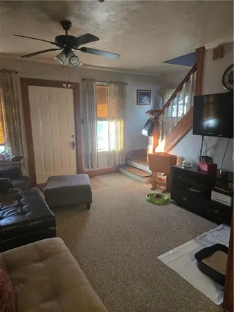 a living room with furniture and a chandelier