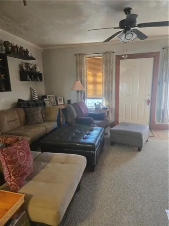 a living room with furniture and a chandelier
