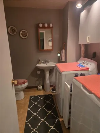 a bathroom with a sink a toilet and mirror
