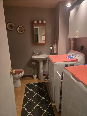 a bathroom with a sink a toilet and mirror