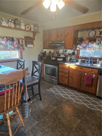 a kitchen with stainless steel appliances granite countertop a stove and a sink