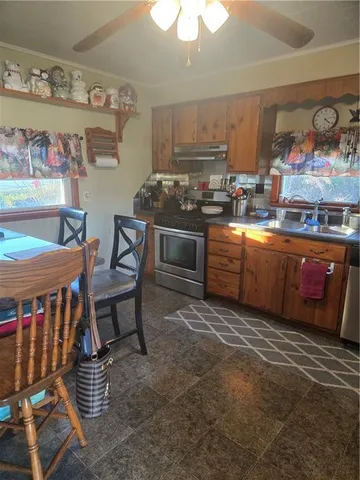 a kitchen with stainless steel appliances granite countertop a stove and a sink