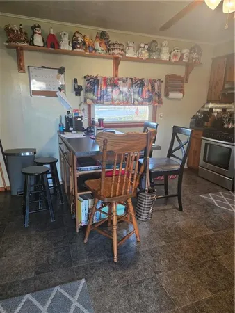 a dining room with a wooden table and chairs
