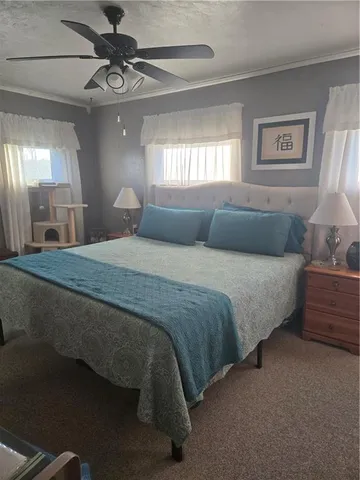a bedroom with a large bed and a chandelier