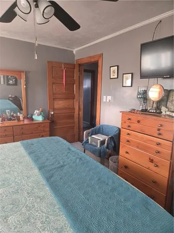 a bedroom with furniture and a mirror