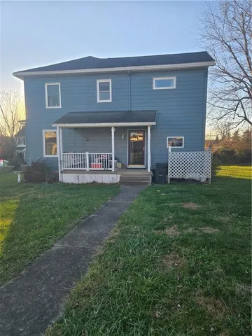 a view of a house with yard and a yard