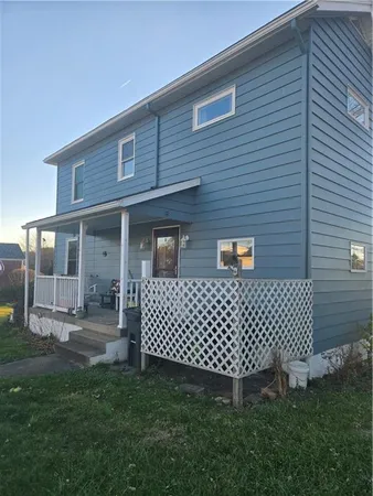 a backyard of a house with table and chairs