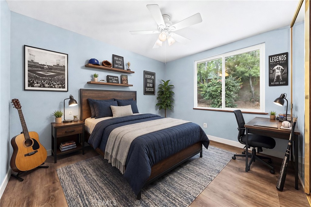 6296 Marble Avenue Rancho Cucamonga, CA 91701 - Photo 53 of 89 a bedroom with a bed a desk and chair with a window