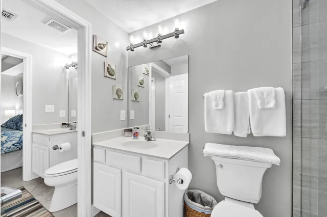 a bathroom with a sink toilet vanity and shower