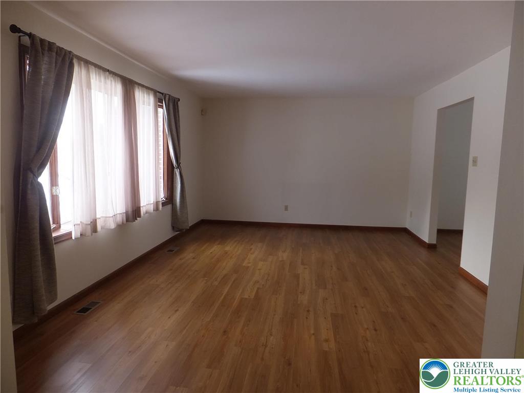 1207 Kressler Road Allentown, PA 18103 - Photo 3 of 27 an empty room with wooden floor and windows