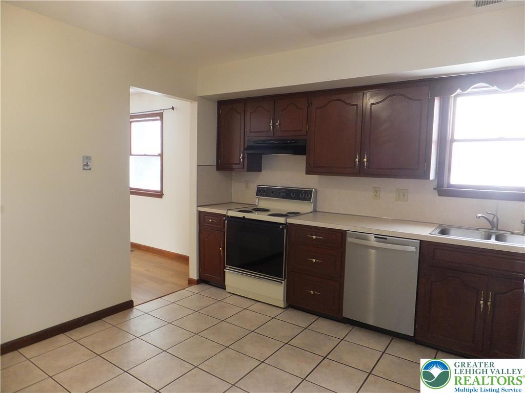 1207 Kressler Road Allentown, PA 18103 - Photo 4 of 27 a kitchen with stainless steel appliances granite countertop a stove a sink and a microwave