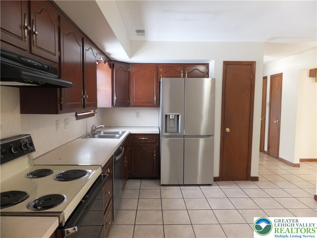 1207 Kressler Road Allentown, PA 18103 - Photo 6 of 27 a kitchen with a stove a refrigerator and a sink