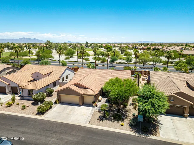 an aerial view of a residential houses with outdoor space