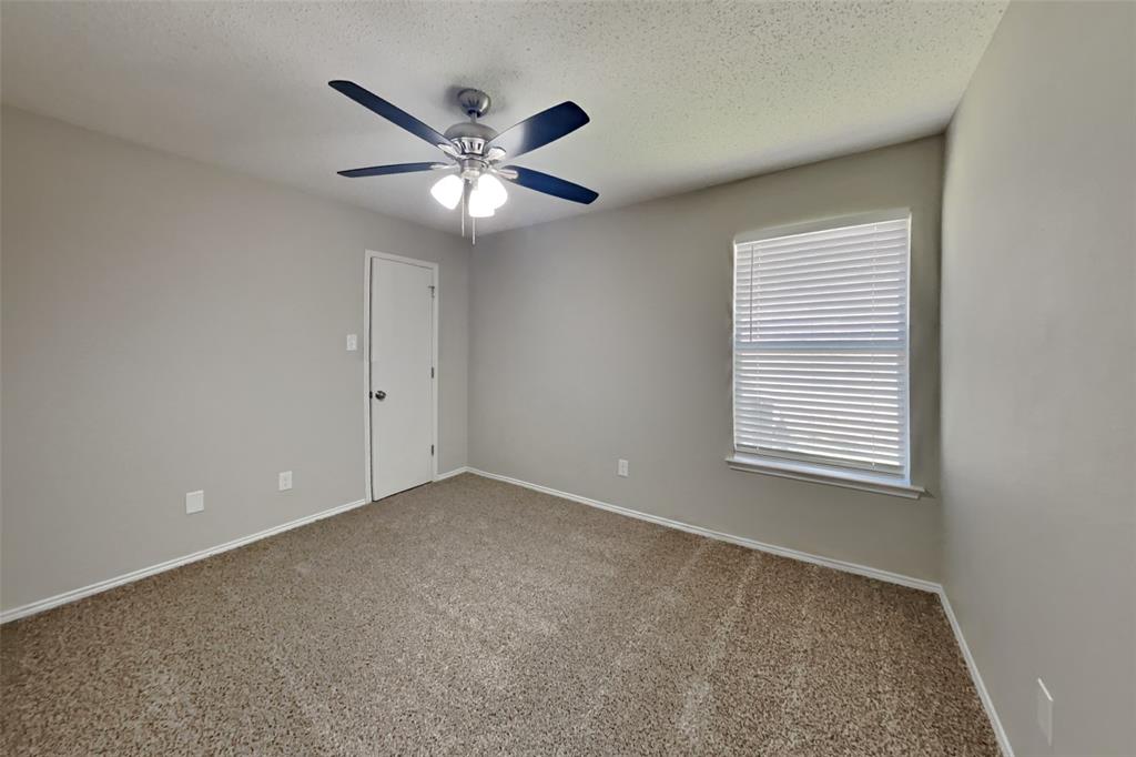 8404 Trinity Vista Trail Fort Worth, TX 76053 - Photo 12 of 18 Spare room featuring carpet floors, a textured ceiling, and ceiling fan