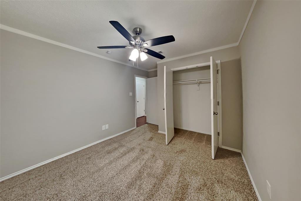 8404 Trinity Vista Trail Fort Worth, TX 76053 - Photo 13 of 18 Unfurnished bedroom featuring crown molding, light colored carpet, a closet, and ceiling fan