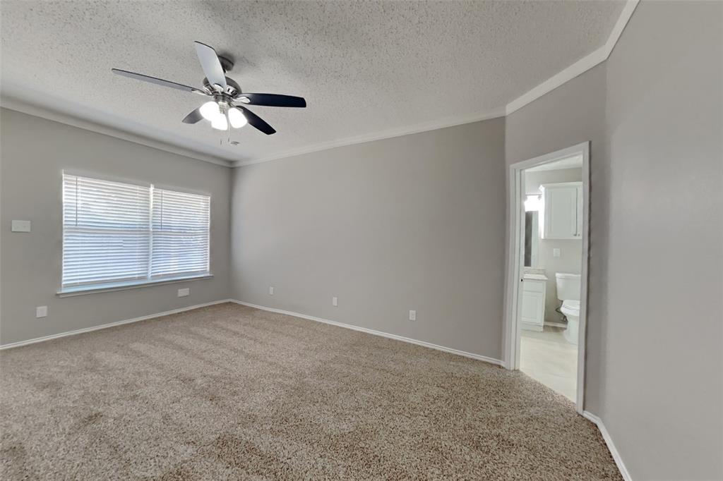 8404 Trinity Vista Trail Fort Worth, TX 76053 - Photo 8 of 18 Spare room with light colored carpet, a textured ceiling, crown molding, and ceiling fan
