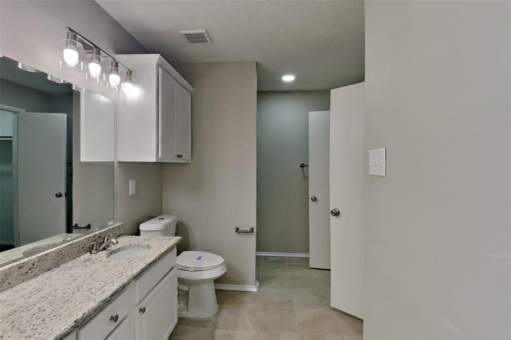 8404 Trinity Vista Trail Fort Worth, TX 76053 - Photo 10 of 18 Bathroom with vanity, light tile patterned flooring, and a closet