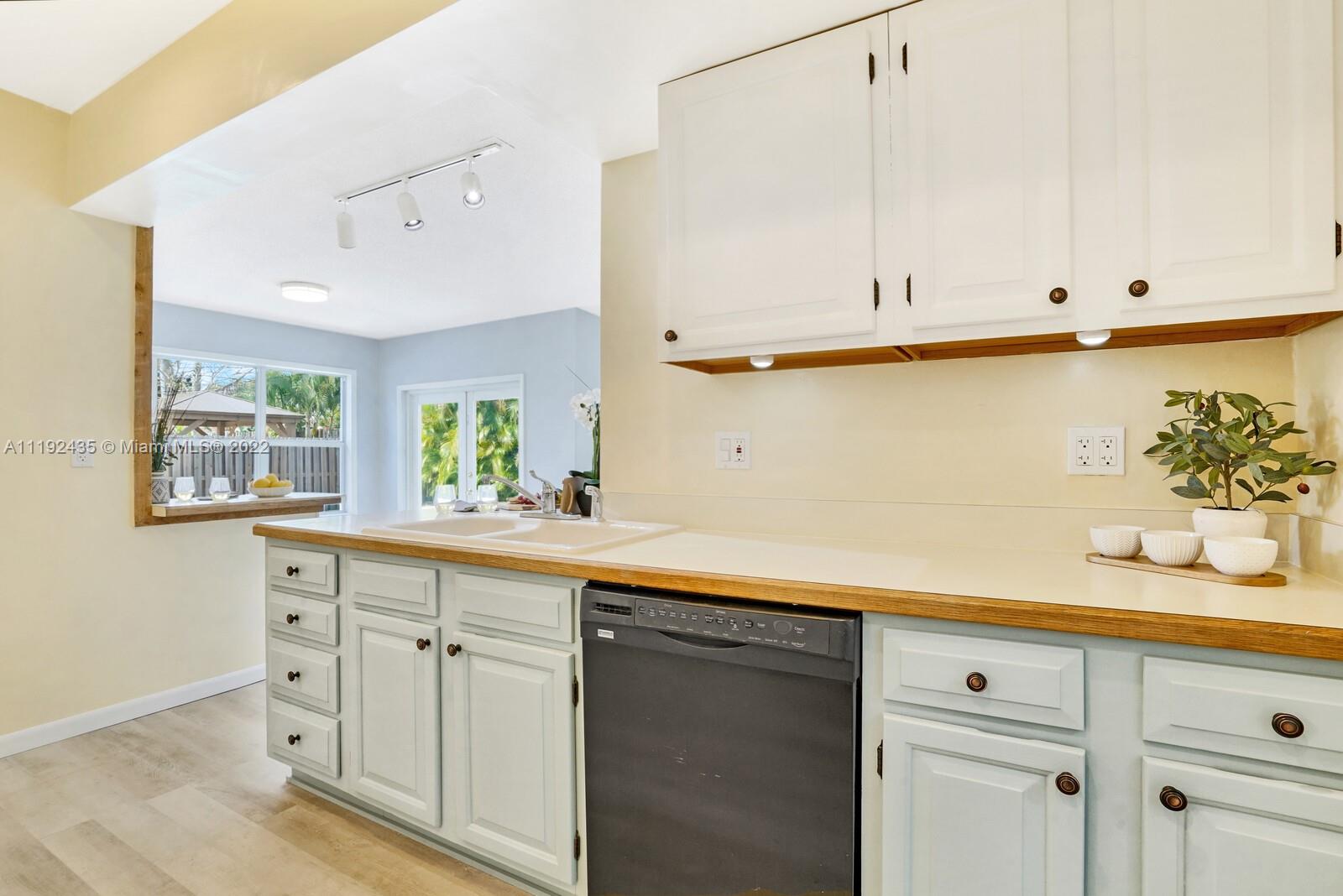 5211 Northeast 26th Avenue Lighthouse Point, FL 33064 - Photo 15 of 43 a kitchen with white cabinets and a sink